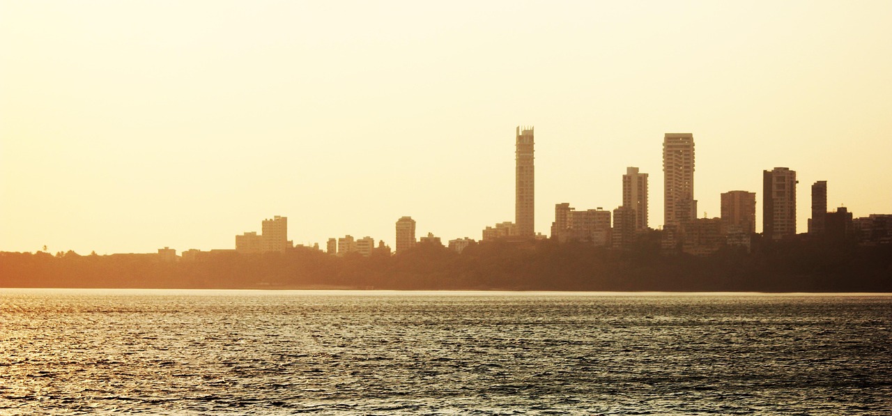 The Mumbai skyline across the Arabian Sea in warm evening light