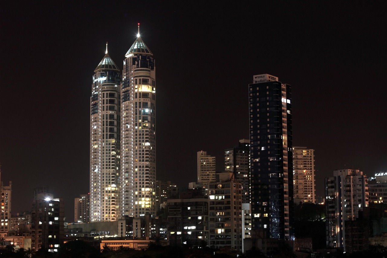 High-rise residential towers lit up at night in Mumbai