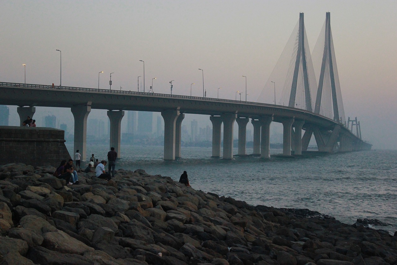 The Sea Link at dusk seen across the rocks of the Mumbai shoreline
